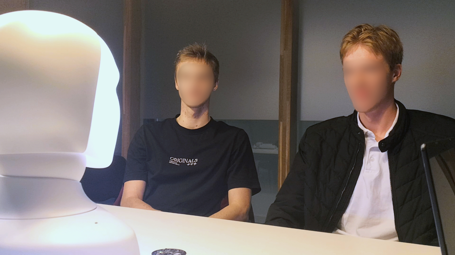 Two participants talking with Furhat during the study.